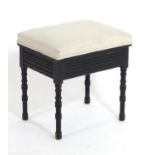 A late 19thC / early 20thC Aesthetic movement ebonised stool with a chamfered frame and ring