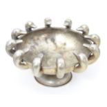 A Greek silver pedestal bowl with hammered decoration and bordered by 12 duck heads. Maker Ilias
