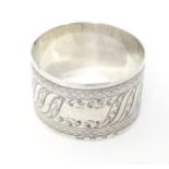 A Victorian silver napkin ring with engraved decoration, hallmarked Birmingham 1894, maker Adie &
