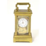 A miniature carriage clock with white enamel dial, marked under with lion rampant stamp. 2 1/2" high