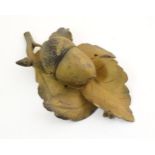 A 20thC carved wooden inkwell modelled as an acorn on oak leaves. Approx. 2 1/4" x 7 1/2" x 5"