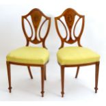 A pair of late 19thC / early 20thC satinwood and marquetry inlaid Hepplewhite style side chairs with