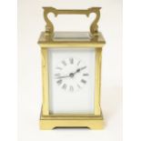 A brass carriage clock marked ACG ( Huber W J) Approx 6" high Please Note - we do not make reference