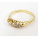 An 18ct gold ring set with five graduated diamonds. Ring size approx. S 1/2 Please Note - we do