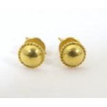 A pair of gold stud earrings. Marked 22k and with Chinese character marks. Approx 1/4" diameter