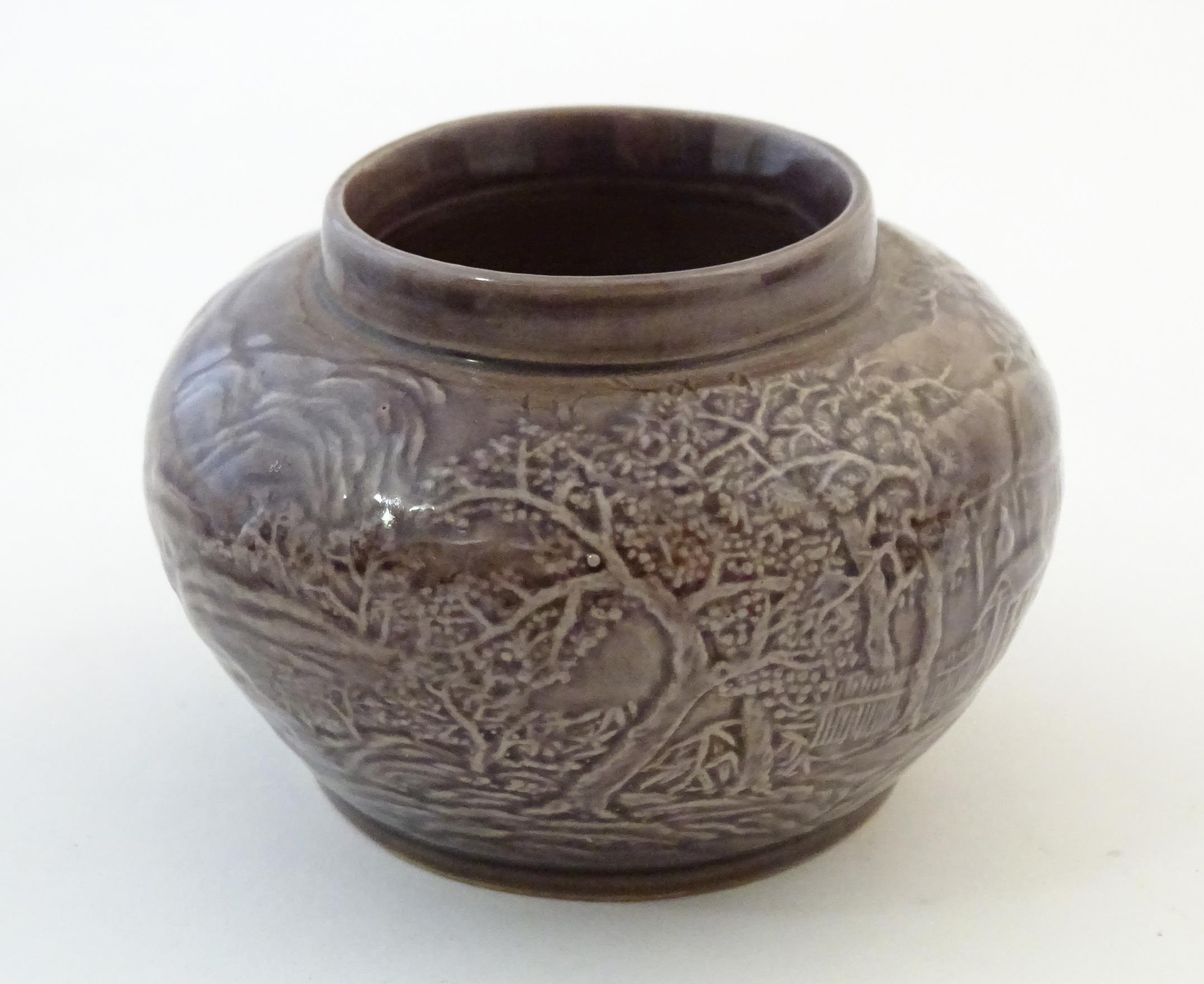 A small Chinese pot of squat form with cast landscape detail. Character marks under. Approx. 2 1/ - Image 2 of 6