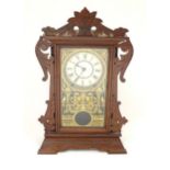 Seth Thomas Clock Co : A late 19thC American walnut cased mantel / gingerbread clock with enamel