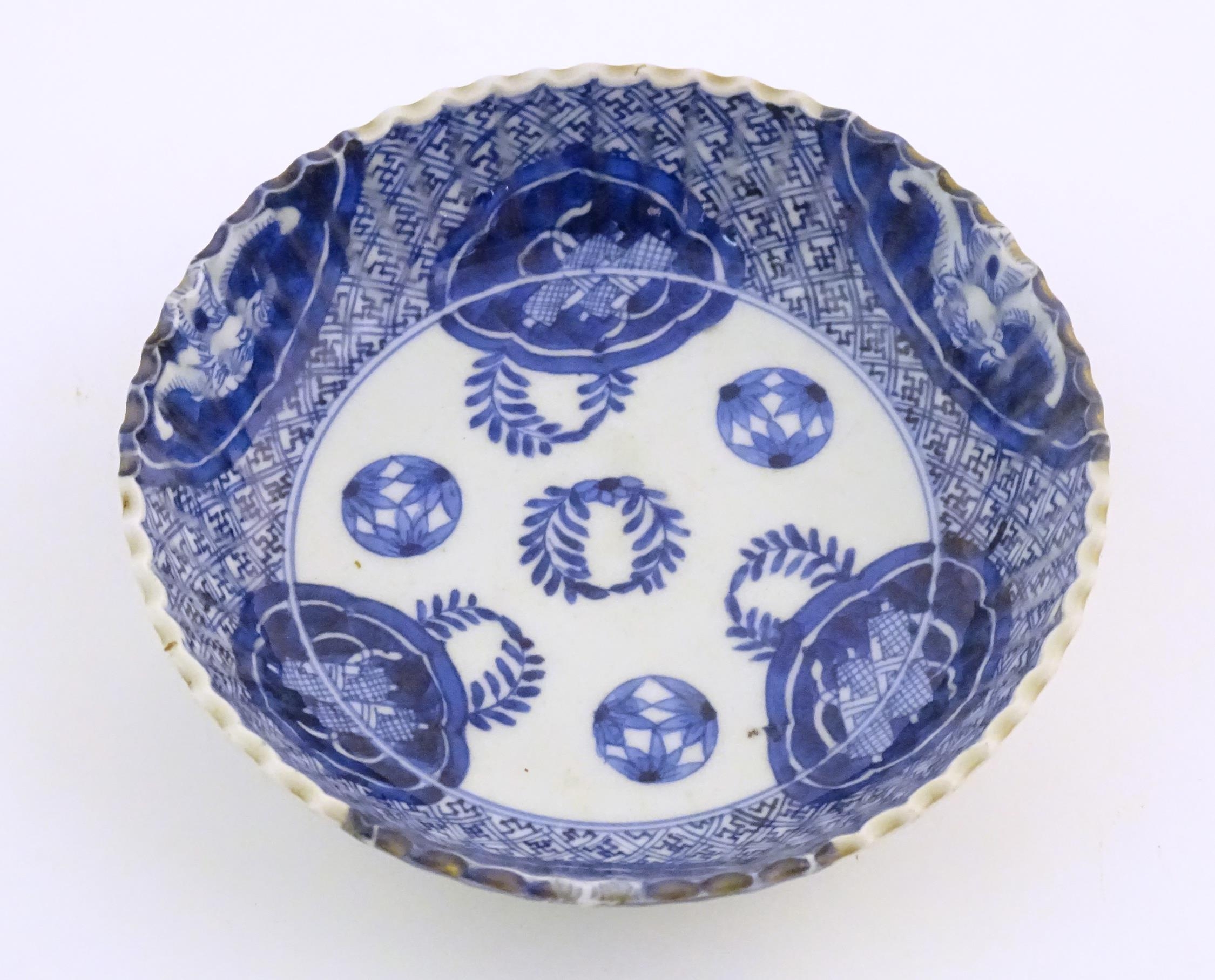 An Oriental blue and white dish with fluted rim, decorated with auspicious scroll symbols, wreaths - Image 2 of 6