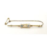 A 15ct gold bar brooch set with central pearl flank by aquamarine. 2 1/4" wide Please Note - we do