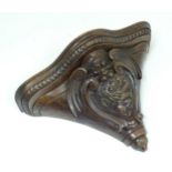A Continental carved walnut wall bracket with an armorial with a lion rampant in a scrolling shield,