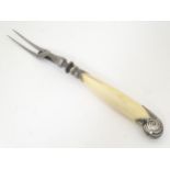 A carving / meat fork with ivory handle having a pistol grip silver mount Hallmarked Sheffield 1887,
