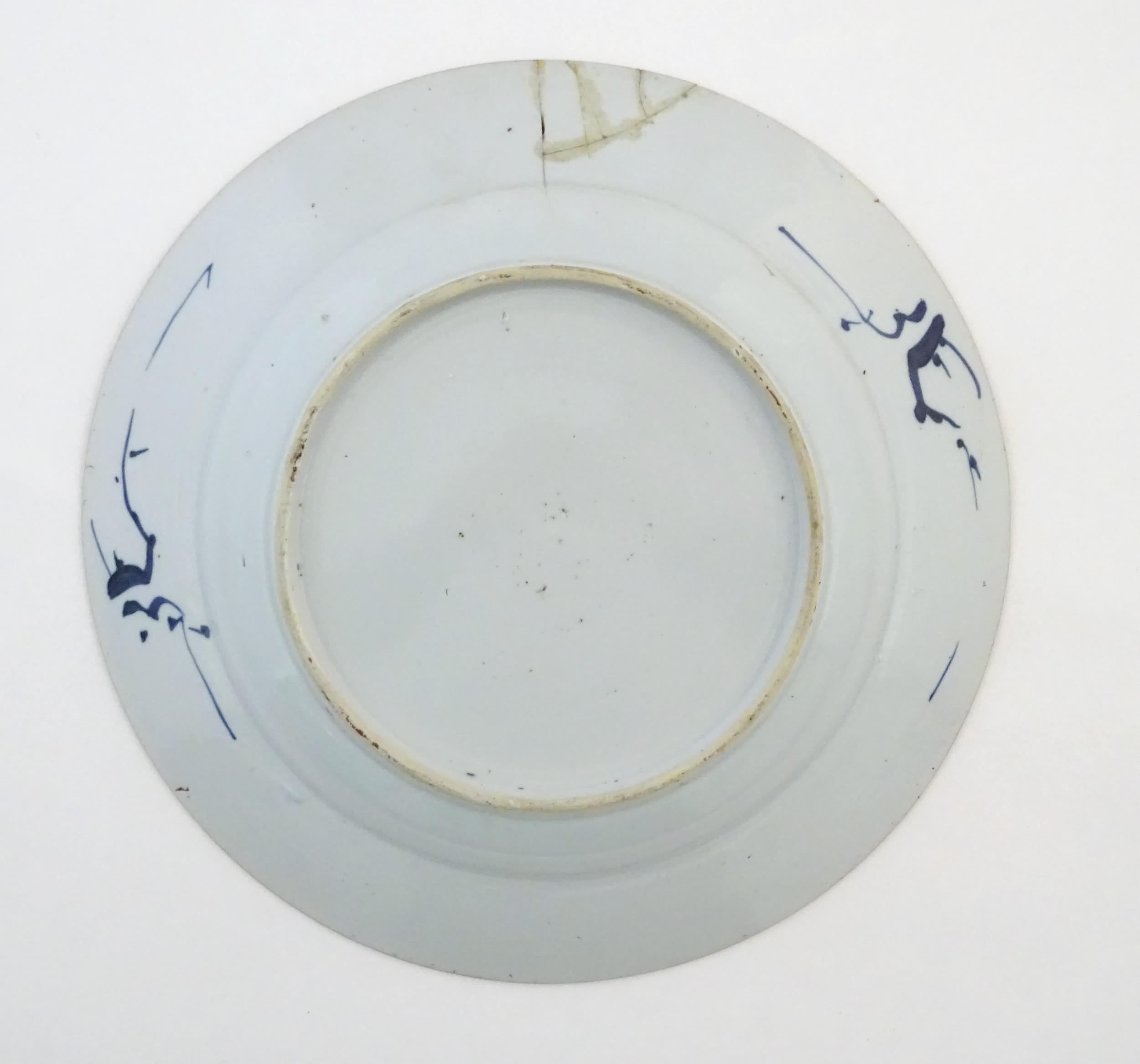 A Chinese blue and white plate decorated with flowers and foliage. With stylised motifs to - Image 3 of 5