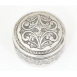 A white metal pot and cover with acanthus scroll decoration. Approx. 3" diameter Please Note - we do