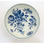 A Worcester blue and white saucer decorated with flowers, foliage and butterflies. Crescent moon