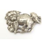 An Oriental white metal decorative mount formed as a Chinese lion dog / Shishi. 1 3/4" long Please