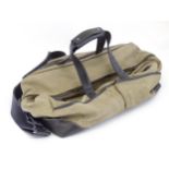 Luggage / Leather bag: A Dunhill canvas and leather holdall with two handles, a shoulder strap and