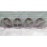 A set of four Victorian cast iron shepherd's hut wheels, each approximately 25" in diameter Please