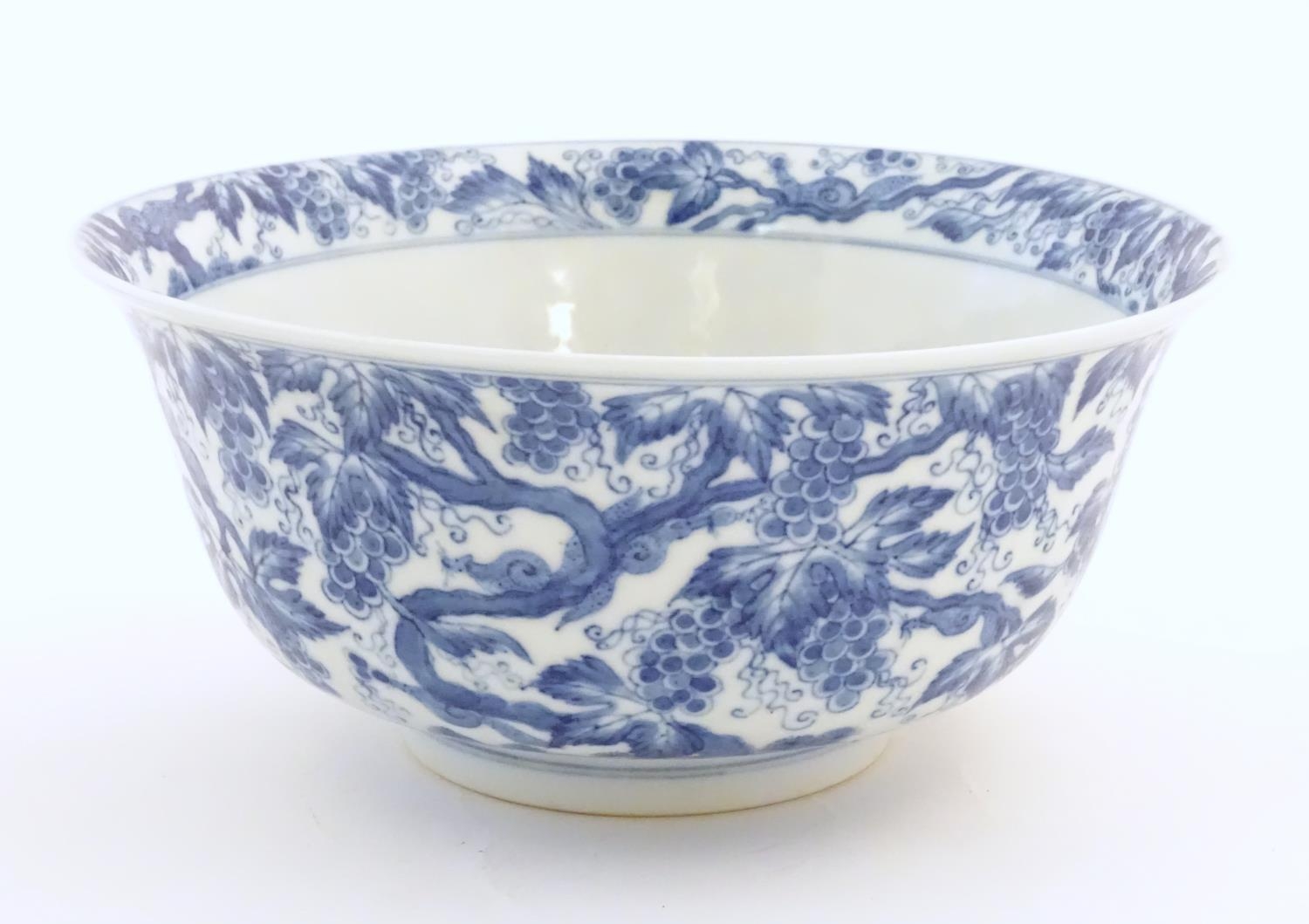 A Chinese blue and white bowl decorated with vine leaves and grapes. Character marks under.