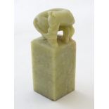 An Oriental soapstone hand seal of squared form with a carved horse to top and Character marks