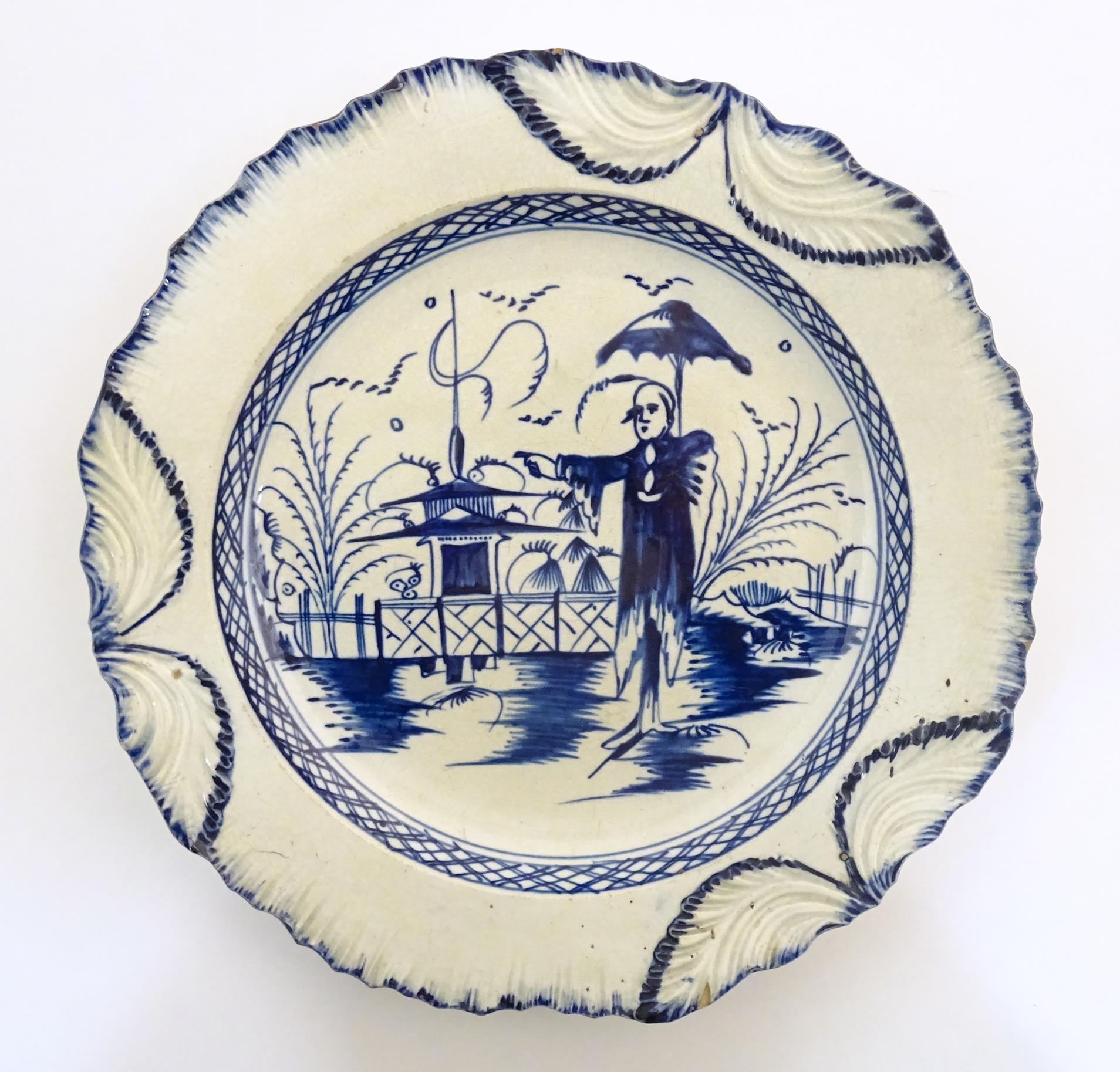 A blue and white pearlware plate decorated in the Long Eliza pattern, depicting a Chinoiserie