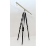 A mid 20thC telescope, with chromed finish, the folding adjustable tripod stand approximately 61" (