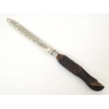 An early 20thC silver plated cake knife by Henry Wilkinson, the carved hardwood handle formed as a