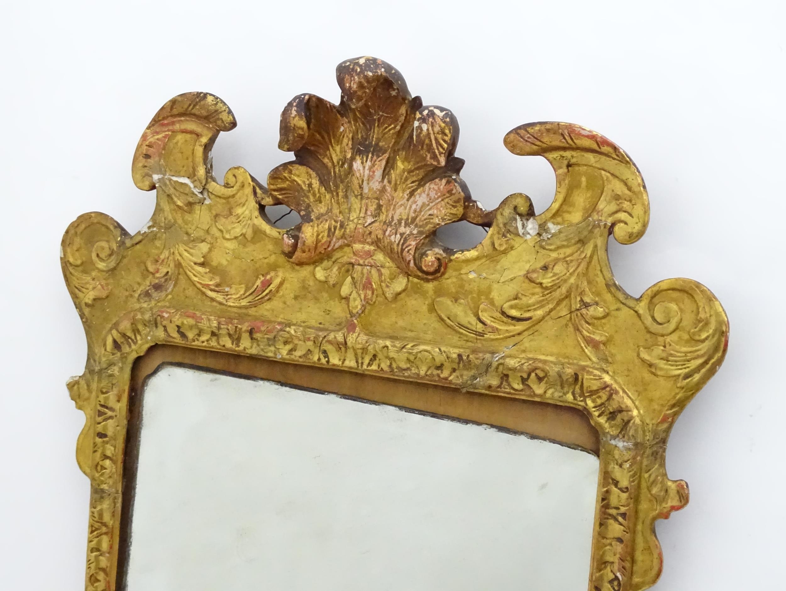 A 19thC gilt mirror with a moulded anthemion to the top and floral decorations to the frame. 23" - Image 2 of 3