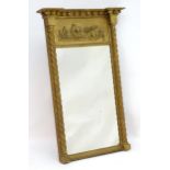 A 19thC gilt pier mirror with a moulded cornice above applied ball decoration and relief style