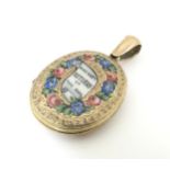 A gilt metal locket with enamel decoration. Approx 1 3/4" long Please Note - we do not make