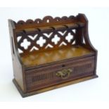 A late 19th / early 20thC oak pipe rack with the provision for 5 pipes, with a pierced back and