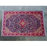 Carpet / Rug : A Sarouk rug, the red and blue grounds with central medallion and floral and