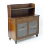 An early / mid 19thC rosewood cabinet with a inlaid bookcase upstand above a rectangular top with