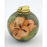 A Moorcroft table lighter of spherical form decorated in the hibiscus flower pattern. Approx. 4 1/2"