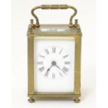 A brass cased carriage clock with white enamel dial 4 1/4" high Please Note - we do not make