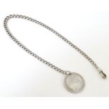 A silver watch chain of graduated curblink form with a Victorian 1 Florin coin. Approx. 14" long
