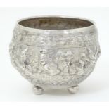 An Eastern white metal bowl with embossed figural detail on three spherical feet. Approx. 4" wide