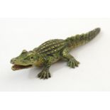 A cold painted bronze model of an alligator / crocodile. Approx. 1 3/4" long Please Note - we do not