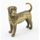 A 20thC brass model of a dog. Approx. 1 3/4" long Please Note - we do not make reference to the