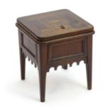 A late 18thC commode with a marquetry inlaid lid above a shaped apron and raised on four tapering