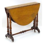 A mid / late 19thC walnut Sutherland table with drop flaps, turned legs and a tapering turned
