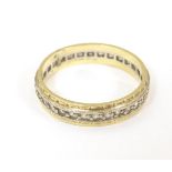 An eternity ring set with white stones and stamped 18ct. Ring Size approx. Size M Please Note - we