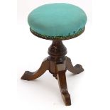 A late 19thC / early 20thC walnut piano stool with an adjustable upholstered top. 20" high. Please