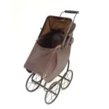 An early 20thC A. W. Gamage Ltd. doll's pram with hood and cover. Approx. 25 1/2" high Please Note -