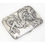 An Oriental white metal cigarette case with cast dragon detail. Marked with Oriental character