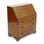 A late 19thC / early 20thC walnut bureau with a fall front above three long drawers having brass