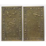 A pair of 20thC brass plaques with embossed style detail, one depicting flowers with butterflies,