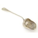 A silver sugar spoon of shovel form with embossed decoration hallmarked 1899, maker G. E. Walton &