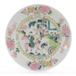 A Chinese famille rose plate depicting a landscape scene with a figure on horse back with an