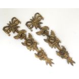 A pair of early 20thC gilt wall appliques / mounts with flower and foliate detail and bow