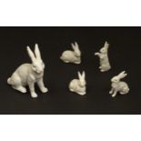 A collection of ceramic Easter Simnel cake decorations formed as rabbits, the largest